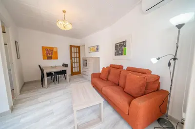 a living room with a couch and a table at HomeHolidaysRentals SantMartin - Costa Barcelona in Calella