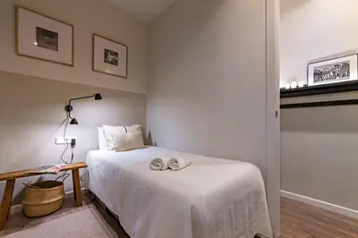 a bedroom with a bed with two towels on it at Habitat Apartments Sweet Sagrada Familia in Barcelona