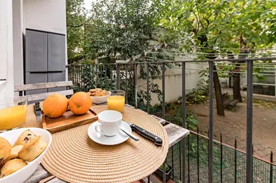 a table with a plate of bread and orange juice at Habitat Apartments Sweet Sagrada Familia in Barcelona