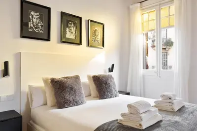 a bedroom with a white bed with towels on it at Enjoy Apartments La Riera One in Barcelona