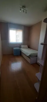a small bedroom with a bed and a window at Precioso Piso Barcelona in Santa Coloma de Cervelló