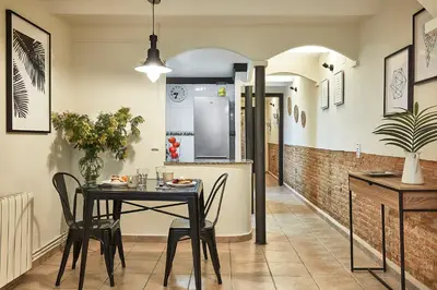 a kitchen and dining room with a table and chairs at BBarcelona Parallel Apartment in Barcelona