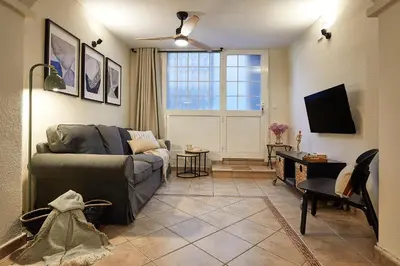 a living room with a couch and a television at BBarcelona Parallel Apartment in Barcelona
