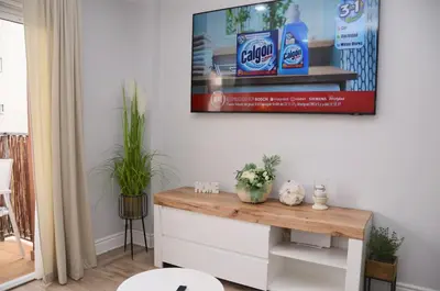 a living room with a tv hanging on the wall at Apartamento Sofia in Pineda de Mar