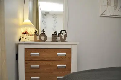 a dresser with a lamp on top of it at Apartamento Sofia in Pineda de Mar