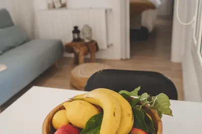 a bowl of fruit on a table in a living room at Casa con encanto in Corbera de Llobregat