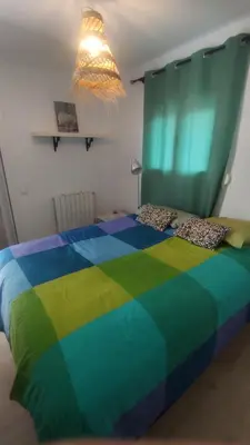 a colorful bed with a colorful blanket on it at Casa con encanto in Corbera de Llobregat