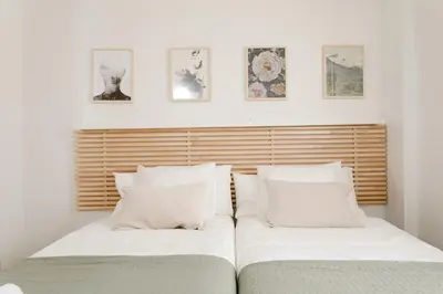 two beds sitting next to each other in a bedroom at AB North Barcelona Apartments in Santa Coloma