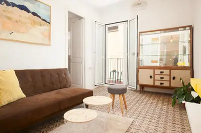 a living room with a couch and two tables at Sagrada Familia V by Enjoy Apartments in Barcelona