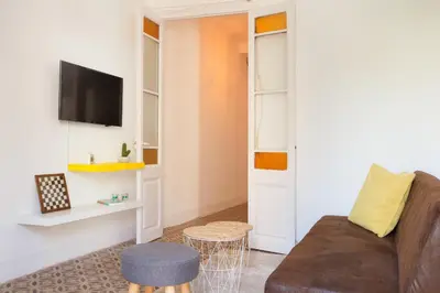 a living room with a couch and a tv at Sagrada Familia V by Enjoy Apartments in Barcelona