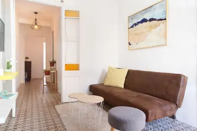 a living room with a brown couch and a table at Sagrada Familia V by Enjoy Apartments in Barcelona