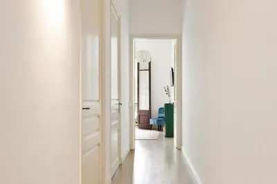 a hallway with white walls and an open door at Sagrada Familia II by Enjoy Apartments in Barcelona