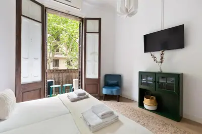 a bedroom with a bed and a tv on a wall at Sagrada Familia II by Enjoy Apartments in Barcelona
