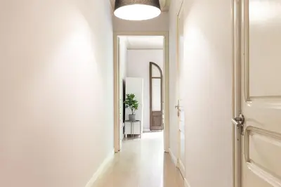 a hallway with white walls and a white door at Sagrada Familia III by Enjoy Apartments in Barcelona