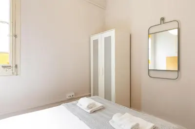 a bedroom with a mirror and a bed with towels at Sagrada Familia III by Enjoy Apartments in Barcelona