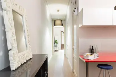 a kitchen with a red counter and a hallway at Sagrada Familia III by Enjoy Apartments in Barcelona