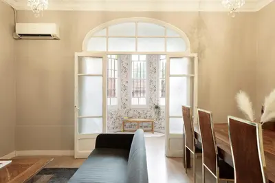 an arched window in a dining room with a couch at Sagrada Familia I by Enjoy Apartments in Barcelona
