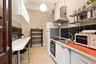 a kitchen with white appliances and a red counter top at Sagrada Familia I by Enjoy Apartments in Barcelona