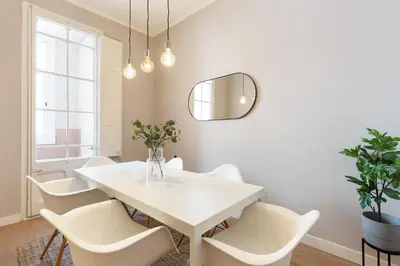 a white dining room with a white table and chairs at Sagrada Familia IV by Enjoy Apartments in Barcelona