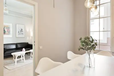 a white living room with a white table and a mirror at Sagrada Familia IV by Enjoy Apartments in Barcelona