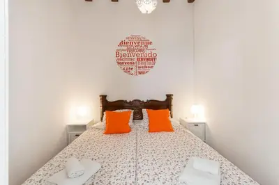 a bedroom with a bed with two orange pillows at Vistamar 1: Primera línea de mar con encanto in Sitges