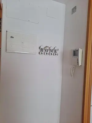 a white refrigerator with a home sign on it at Precioso loft al lado Parc Vallparadís by Lofties in Terrassa