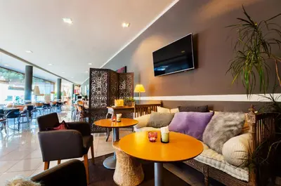 a living room with a couch and tables at PARK SEDO Aparthotel in Rubí