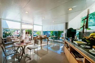 a kitchen with a table and chairs in a room at PARK SEDO Aparthotel in Rubí