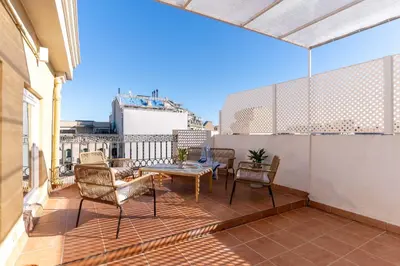a patio with a table and chairs on a balcony at SibsBcn-Paseo de Gracia Penthouse-Luxury-Terraces in Barcelona