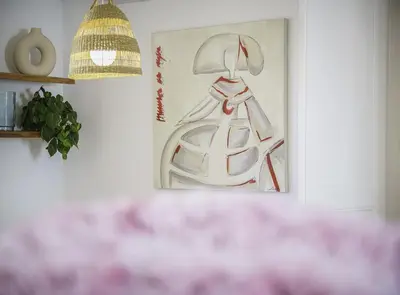 a painting of a woman in a hat on a wall at SibsBcn-Paseo de Gracia Penthouse-Luxury-Terraces in Barcelona