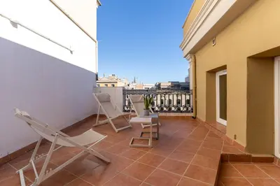 a balcony with chairs and a view of the city at SibsBcn-Paseo de Gracia Penthouse-Luxury-Terraces in Barcelona