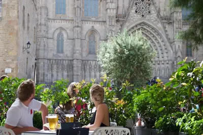 two people sitting at a table in front of a building at Lamaro Hotel Barcelona - Preferred Hotels & Resorts - Lifestyle Collection in Barcelona