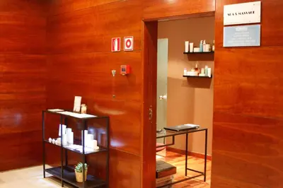 a room with a wooden door and shelves with products at Hotel Best Front Maritim in Barcelona