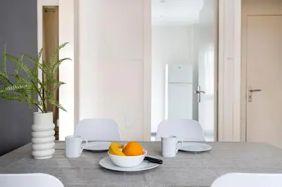 a dining room table with a bowl of oranges on it at Apartments Sata Sagrada Familia Area in Barcelona