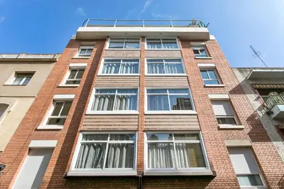 a red brick building with many windows on it at Apartments Sata Sagrada Familia Area in Barcelona
