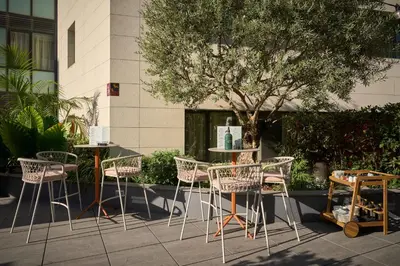 a group of chairs and tables in front of a building at Catalonia Ramblas 4* Sup in Barcelona
