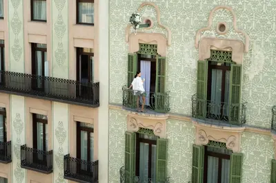 a man standing on a balcony of a building at Catalonia Ramblas 4* Sup in Barcelona