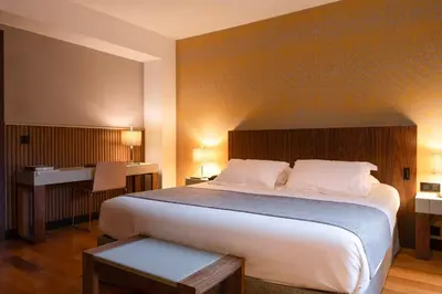 a bedroom with a large bed and a desk at Hotel Villa Emilia in Barcelona