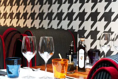 a table with wine glasses and bottles on it at Hotel Villa Emilia in Barcelona