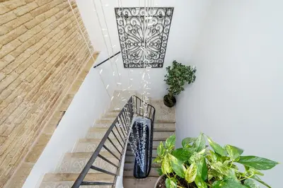 an overhead view of a staircase with plants at Hauzify I Novavila Centre Rooms in Vilanova i la Geltrú