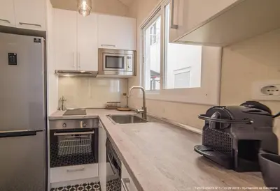 a small kitchen with a sink and a refrigerator at Welcomy Poblenou in Barcelona