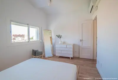 a bedroom with a bed and a dresser and a window at Welcomy Poblenou in Barcelona