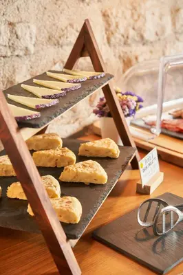 a display of breads and pastries on a shelf at Mercer House Bòria BCN in Barcelona