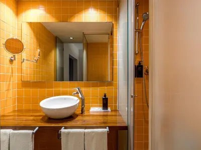 a bathroom with a sink and a mirror at Mercer House Bòria BCN in Barcelona