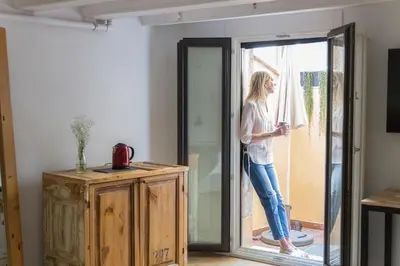 a woman standing outside of a glass door at Eco Boutique Hostal Grau in Barcelona