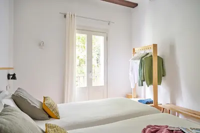 a bedroom with two beds and a window at Eco Boutique Hostal Grau in Barcelona