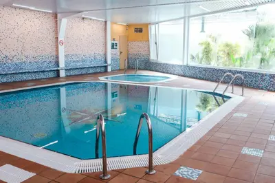 a pool in a hotel room with a swimming pool at KAKTUS Hotel Kaktus Playa in Calella