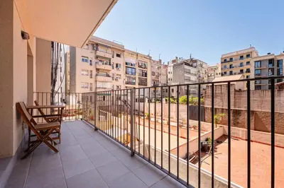 a balcony with a chair and some buildings at Sweett - Casa Bailen in Barcelona