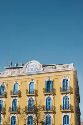 a yellow building with a sign on top of it at Fonda Hotel 1771 in Granollers