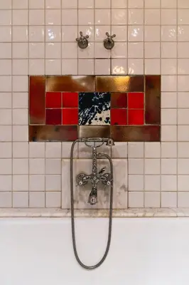 a shower in a tiled bathroom with a hose at Fonda Hotel 1771 in Granollers
